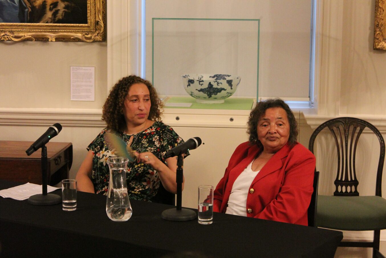 E.L. Norry and Ann Evans side by side at a panel discussion