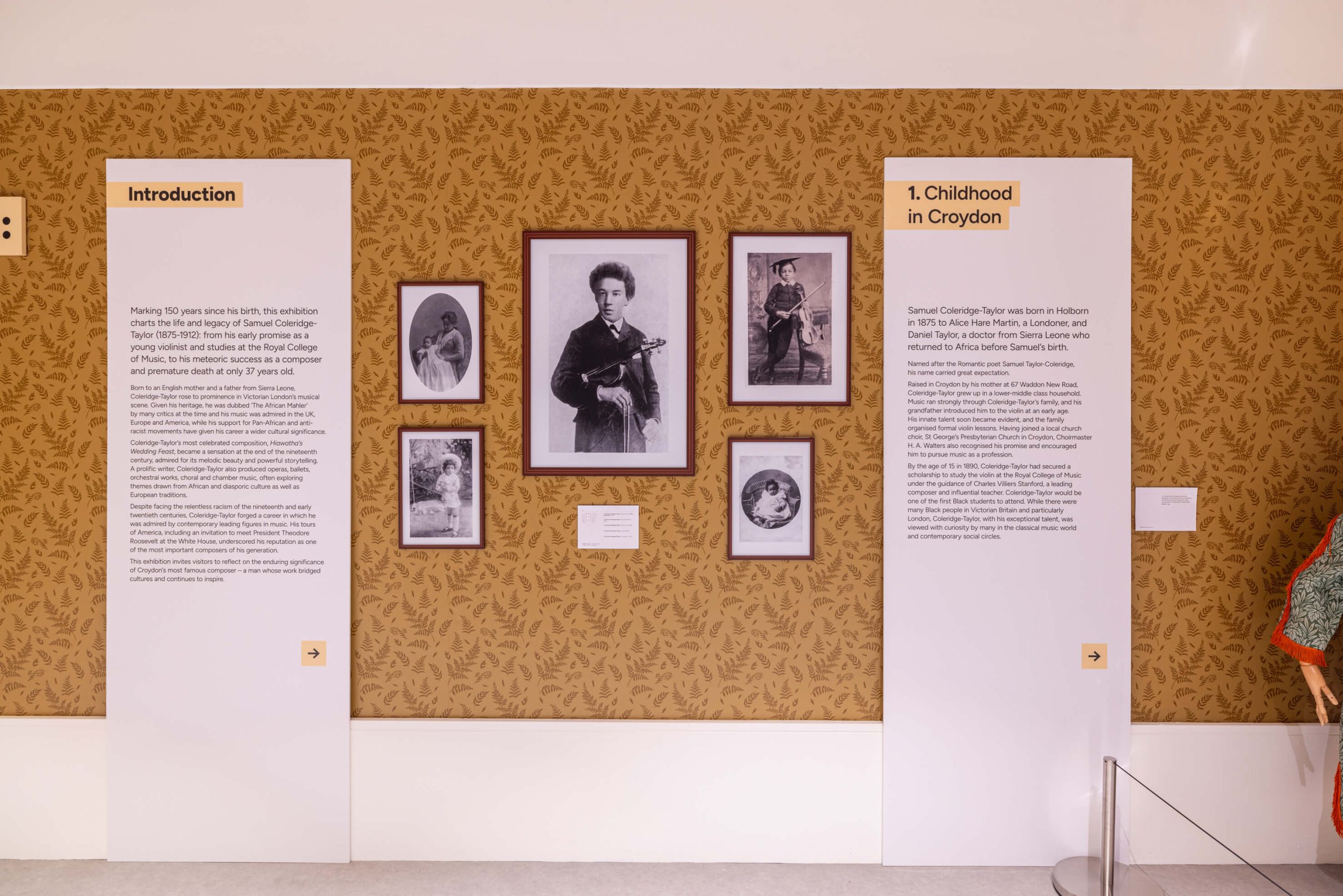 Sound of Croydon museum display on Samuel Coleridge-Taylor’s childhood, with text panels and framed portraits arranged on patterned wallpaper in a Victorian-style setting.