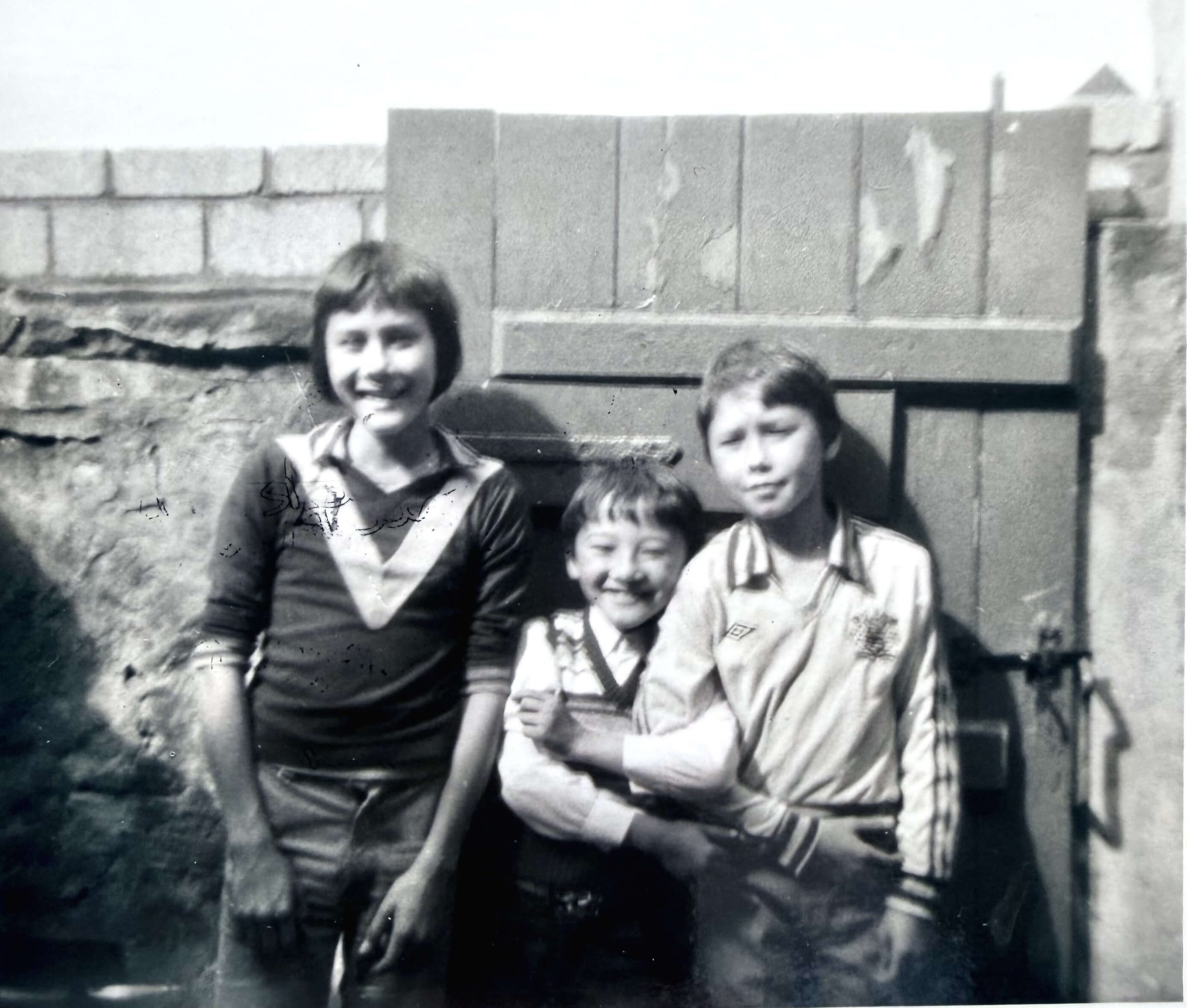 Allan O'Neill and his brothers Michael and Kieran in the back yard of their childhood home in Padiham. Lancashire in the 1960s.