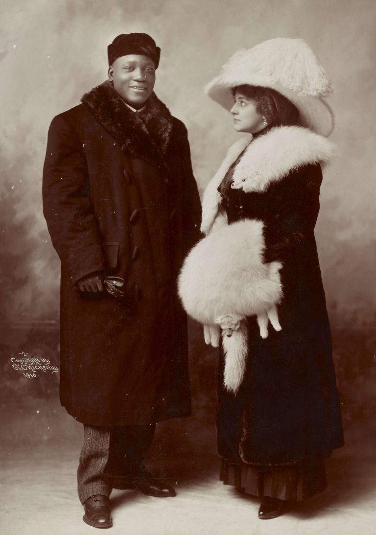 Jack Johnson and his wife Etta Duryea, 1910.  The pair were likely who the Spaldings' attackers were referring to when they shouted 'Kill all Johnsons'. Image; Chickering, Elmer, copyright claimant, Public domain, via Wikimedia Commons