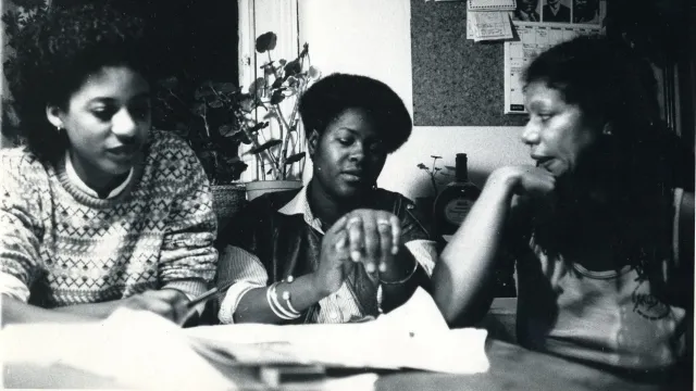 Suzanne Scafe, Beverley Bryan and Stella Dadzie sit together around a table in discussion during work on The Heart of the Race.