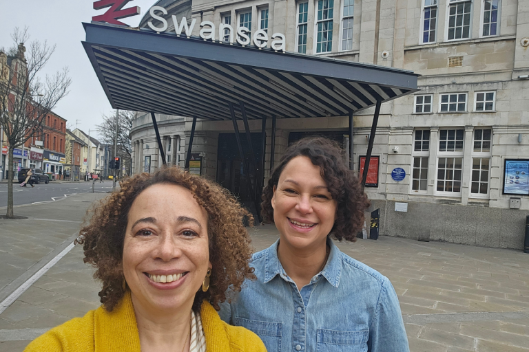 Chamion and Laura Swansea 202500 px) Chamion Caballero and Laura Smith smiling at the camera outside Swansea train station
